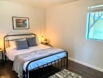 first guest bedroom with queen bed